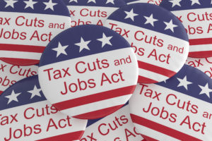usa-politics-news-badges-pile-of-tax-cuts-and-jobs-act-buttons-with-us-flag-3d-illustration