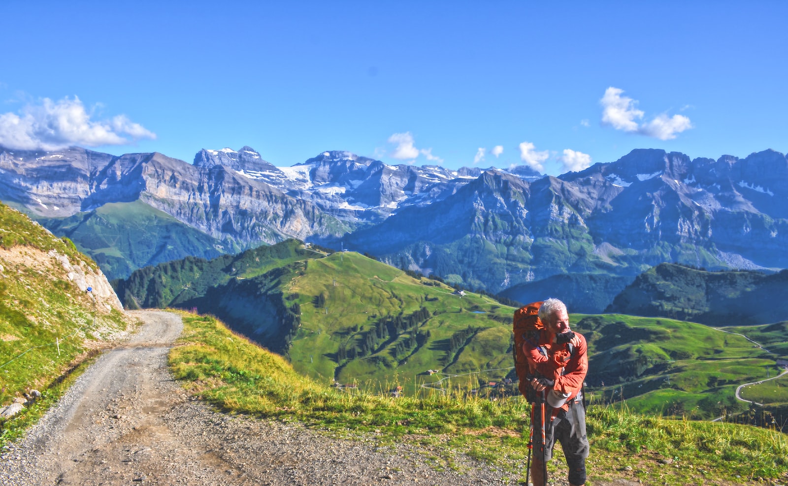 man standing far away from mountains